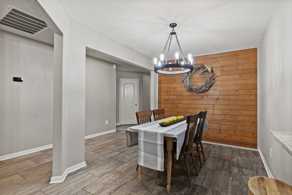 217 Farmer Lane Jarrell, TX 76537 - Photo 8 of 29 Spacious dining room featuring a wood accent wall.