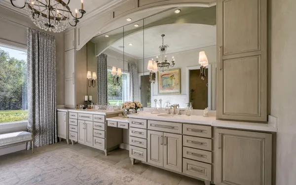 a spacious bathroom with a double vanity sink a large mirror and a bathtub