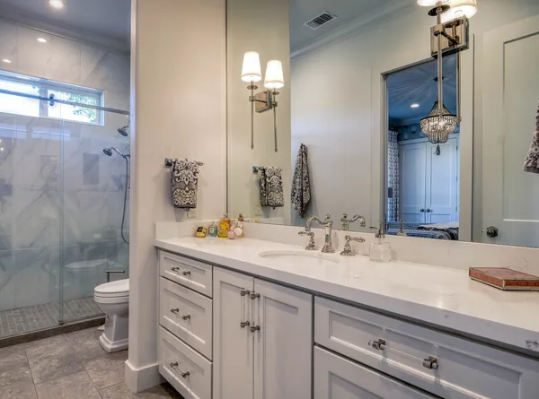 a bathroom with a sink double vanity granite and a mirror