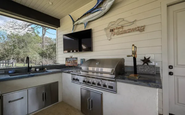 a kitchen with a sink a stove and cabinets