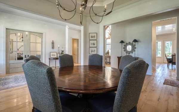 a dining room with furniture and wooden floor