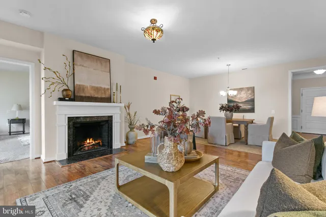 a living room with furniture a fireplace and a table