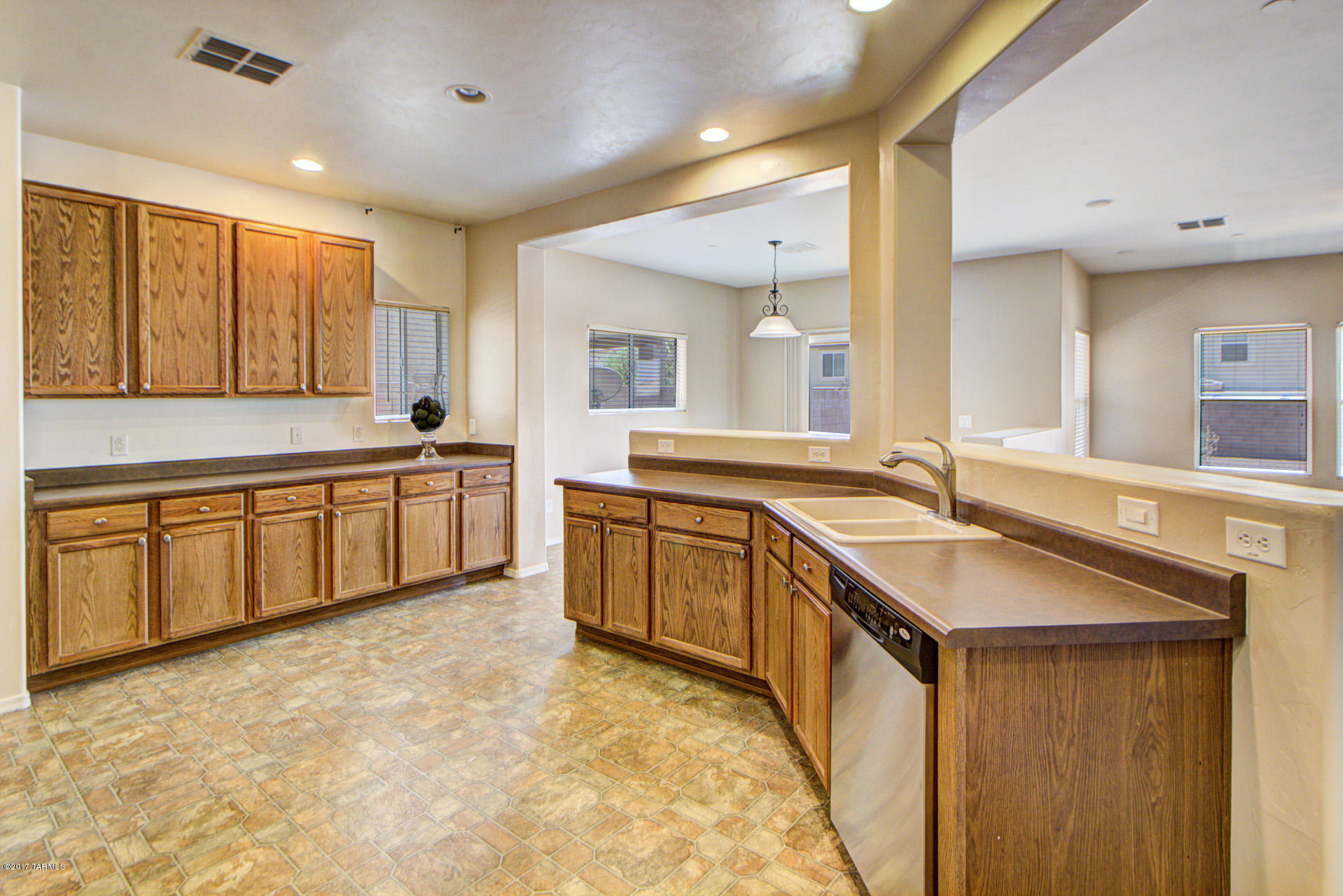 3588 East Mecate Road Tucson, AZ 85739 - Photo 12 of 36 a large kitchen with a sink and a large window