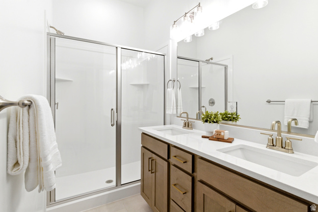 7243 West Terraine Road West Jordan, UT 84081 - Photo 14 of 31 Double vanity with undermount sinks, white countertops, and brushed nickel fixtures