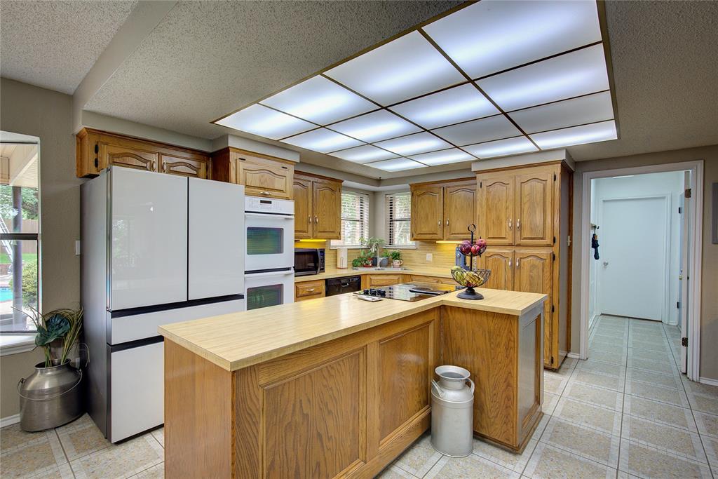 753 County Rd SW 3110 Mount Vernon, TX 75457 - Photo 10 of 40 Kitchen has large island, double wall ovens, corner sink, electric cooktop, dishwasher and pantry cabinet. Walk-in pantry is just steps away.