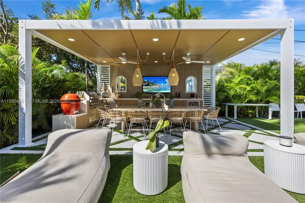 a building outdoor space with patio furniture and potted plants