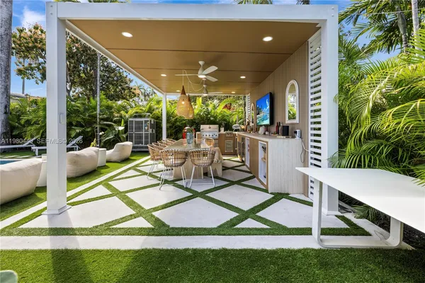 a view of a yard with plants and palm trees