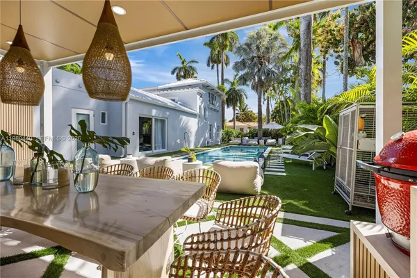 a living room with furniture and large windows