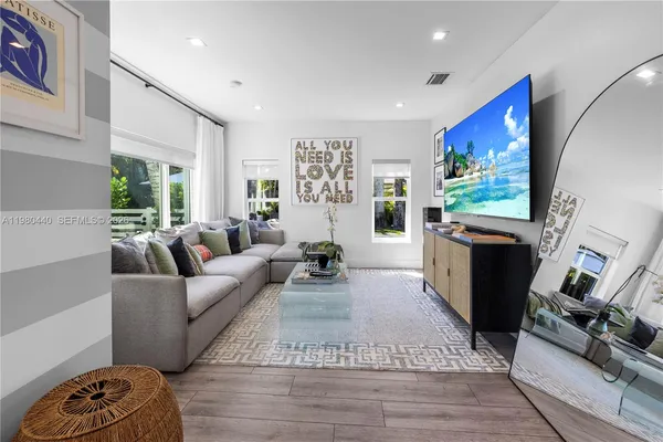 a large kitchen with lots of counter space and wooden floor