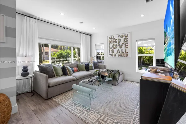 a view of living room with wooden floor and furniture