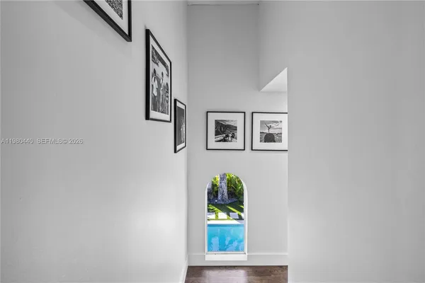 a kitchen with stainless steel appliances granite countertop a refrigerator a sink dishwasher a stove and white countertops with wooden floor