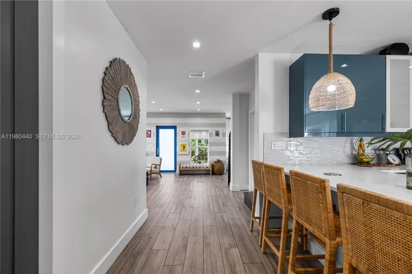 a view of a dining room with furniture a chandelier and wooden floor