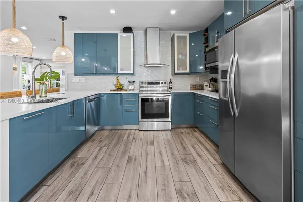 a bedroom with a bed a desk and chair with wooden floor