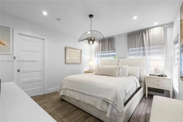 a view of entryway and hall with wooden floor