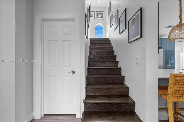 a bedroom with a bed and a large window with balcony view