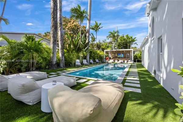 a swimming pool with outdoor seating yard and patio