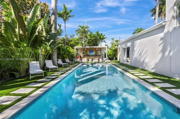 a view of a pool with chairs