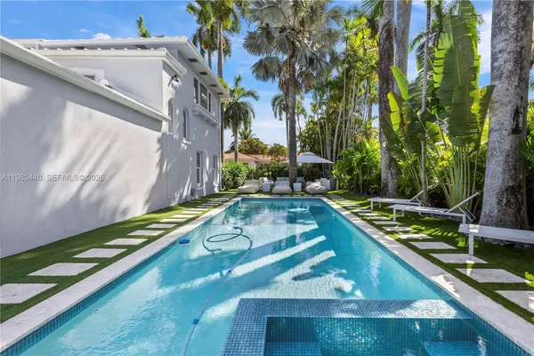 a view of a patio with couches table and chairs potted plants and palm tree