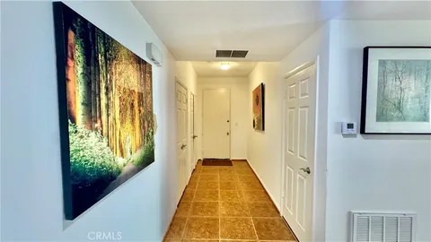a bedroom with a bed and a dresser next to a window