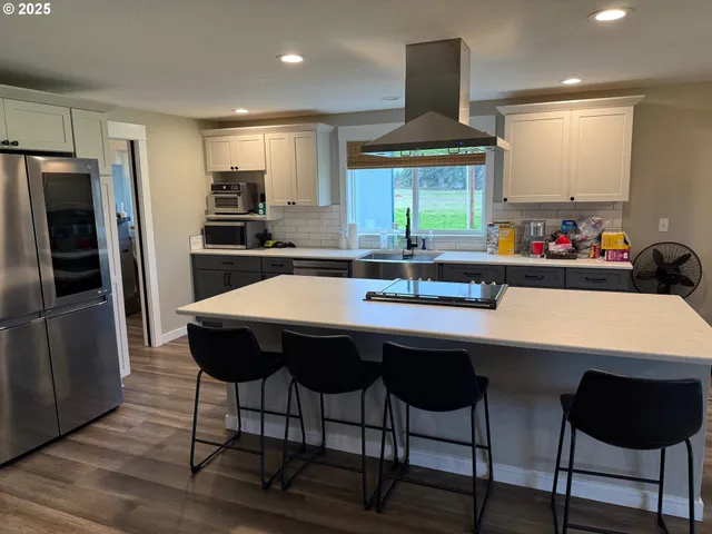 a kitchen with stainless steel appliances a sink and a refrigerator