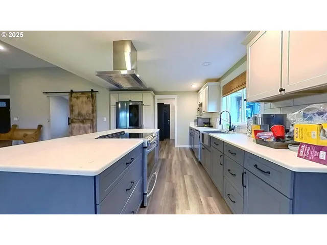 a open kitchen with stainless steel appliances granite countertop a sink window and cabinets