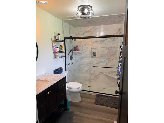 a bathroom with a sink a toilet and a mirror