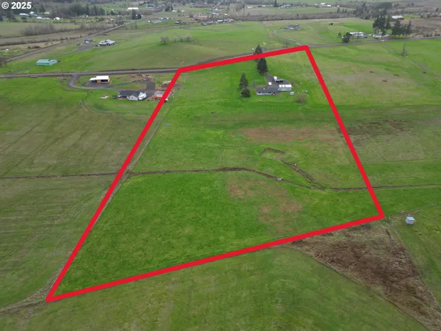 an aerial view of a houses with a yard