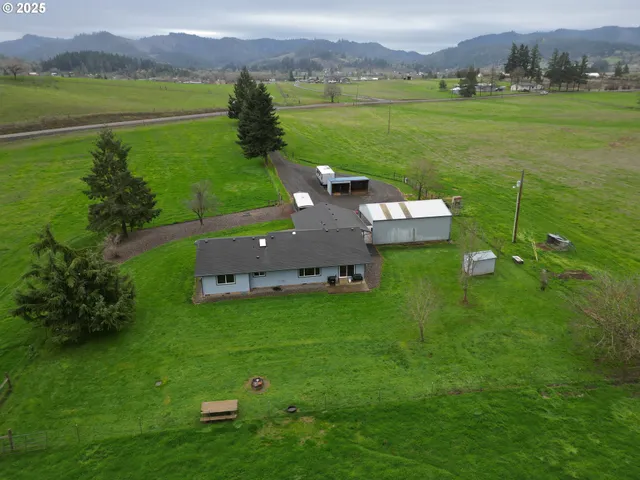 a view of a house with a yard and garage