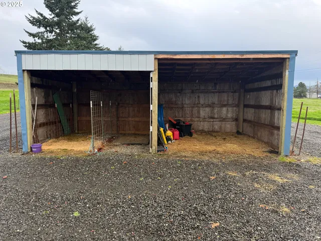a view of a house with large space and a car parked in it