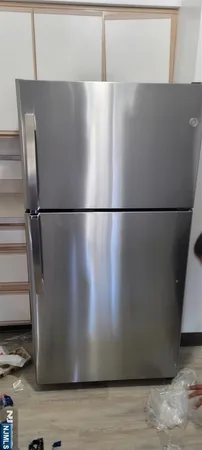 a view of a refrigerator in kitchen