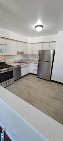 a kitchen with stainless steel appliances granite countertop a sink counter space and cabinets