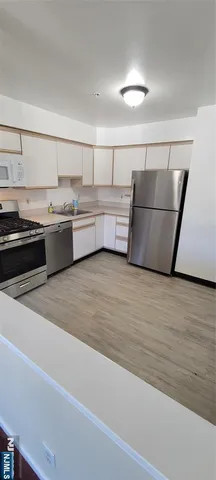 a kitchen with stainless steel appliances granite countertop a sink counter space and cabinets