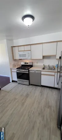 a kitchen with granite countertop a stove and a sink