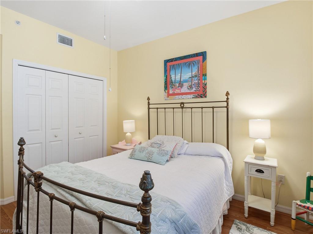 20161 Bravada Street, Unit 2 Estero, FL 33928 - Photo 19 of 33 a bedroom with a bed and a painting on the wall
