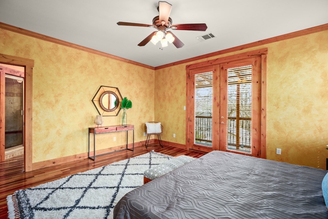 912 East 51st Street Austin, TX 78751 - Photo 12 of 38 a bed room with a bed and a chandelier