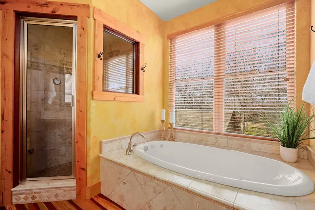 a white bath tub sitting next to a shower