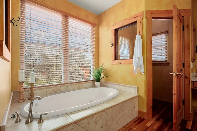 a bathroom with a granite countertop tub and a sink