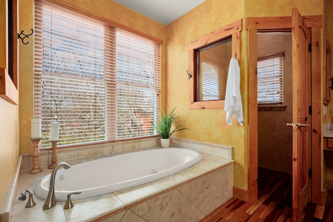 912 East 51st Street Austin, TX 78751 - Photo 15 of 38 a bathroom with a granite countertop tub and a sink