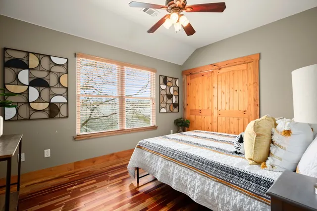a bedroom with a bed and wooden floor