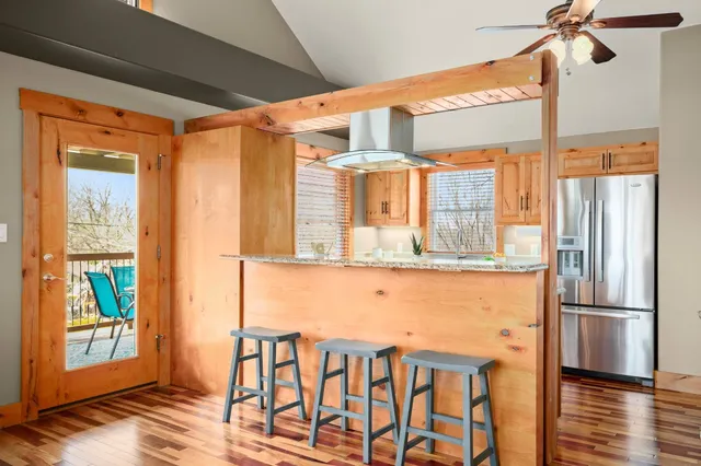 a front view of a house with wooden floor and windows