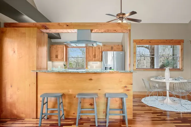 a dining room with wooden floor and a table