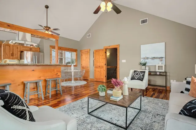 a living room with furniture a dining table and a rug