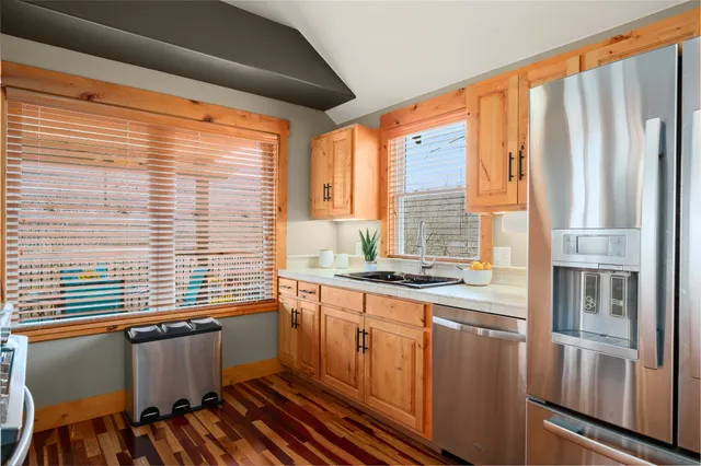 a kitchen with a large window and cabinets