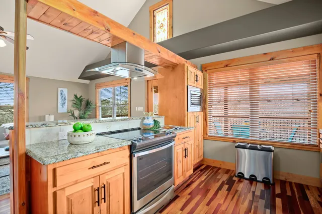 a kitchen with stainless steel appliances granite countertop sink stove and cabinets