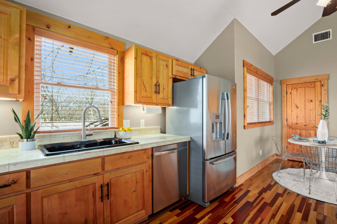 912 East 51st Street Austin, TX 78751 - Photo 35 of 38 a kitchen with stainless steel appliances a refrigerator and a sink
