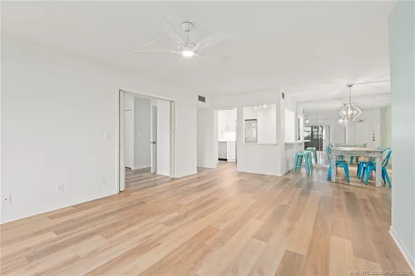 a view of a livingroom with furniture and a kitchen