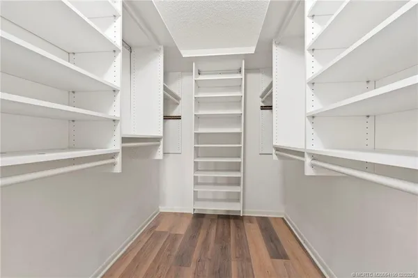 a view of walk in closet with empty racks