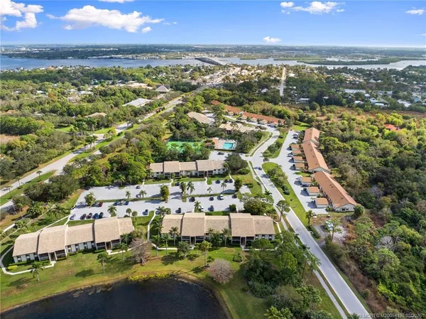 a view of a city with lots of residential buildings ocean and mountain view in back