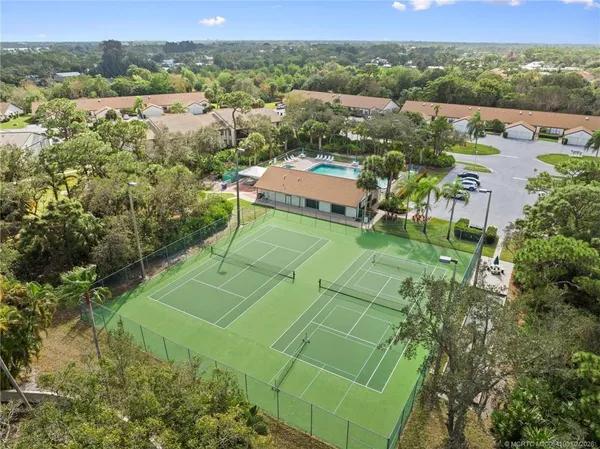 an aerial view of a house with a yard