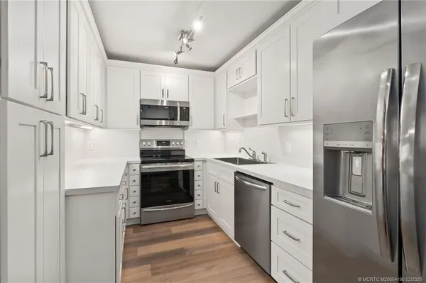 a kitchen with cabinets and a stove top oven